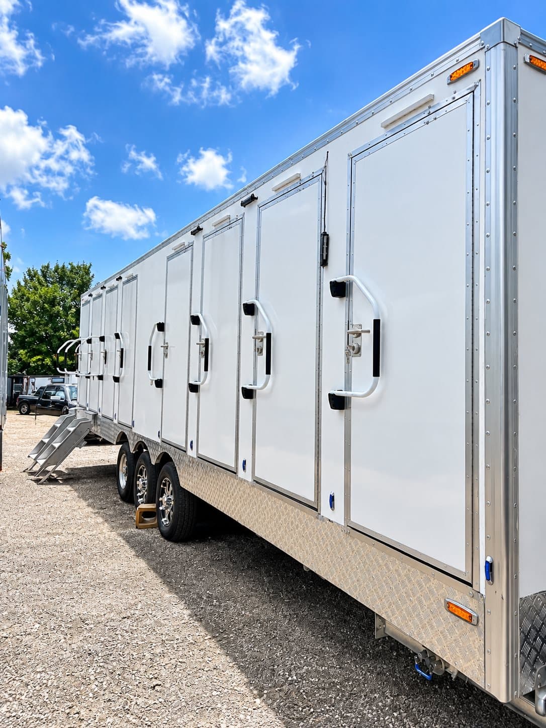 Side view of a 30 ft eight-stall luxury shower and restroom combination trailer